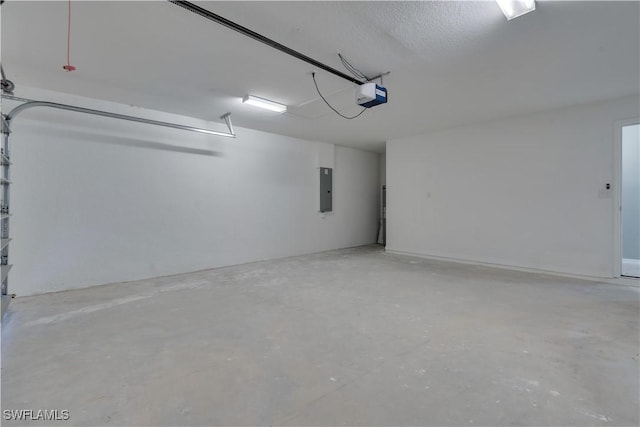 garage with a garage door opener and electric panel