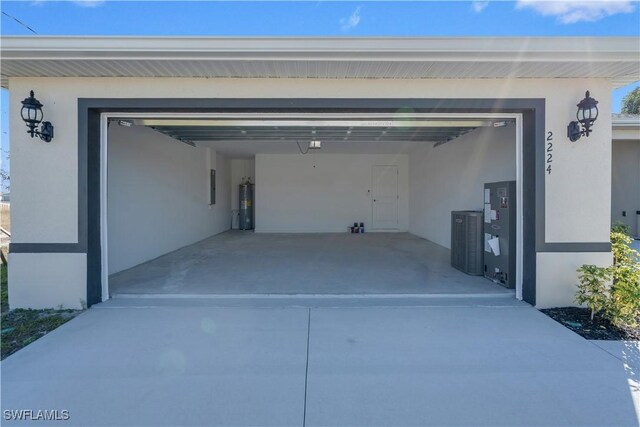 garage featuring electric panel and electric water heater