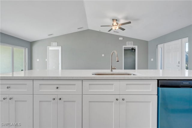 kitchen with dishwasher, white cabinetry, sink, and light stone counters