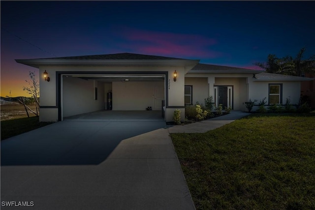 view of front of house featuring a garage and a lawn