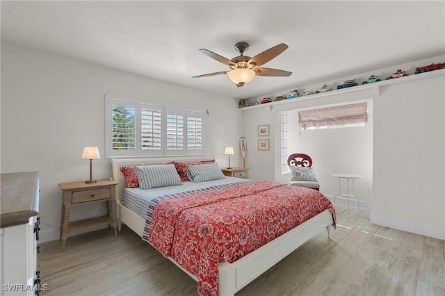 bedroom featuring ceiling fan, wood finished floors, and baseboards