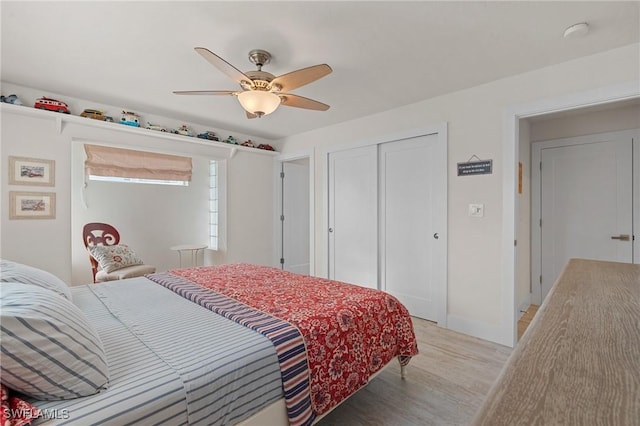 bedroom featuring a ceiling fan, light wood-type flooring, and a closet