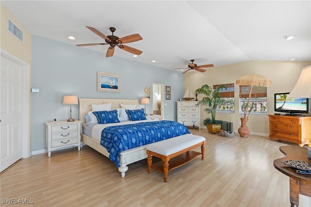 bedroom featuring light wood-style floors, baseboards, visible vents, and vaulted ceiling