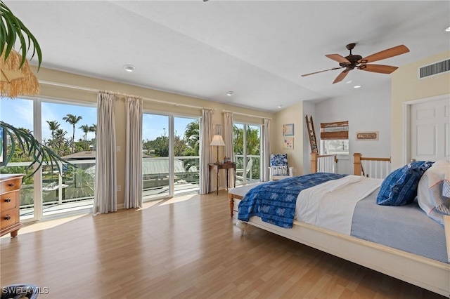 bedroom with access to exterior, vaulted ceiling, visible vents, and light wood-style floors