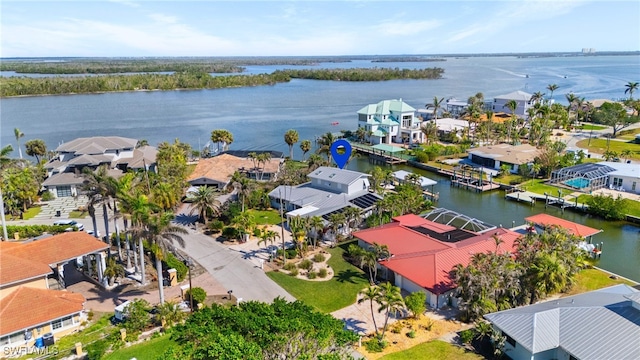 birds eye view of property with a water view and a residential view