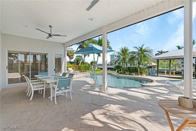 outdoor pool featuring a ceiling fan, outdoor dining area, and a patio area