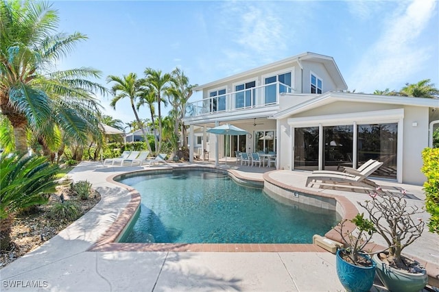 pool with a patio area and ceiling fan