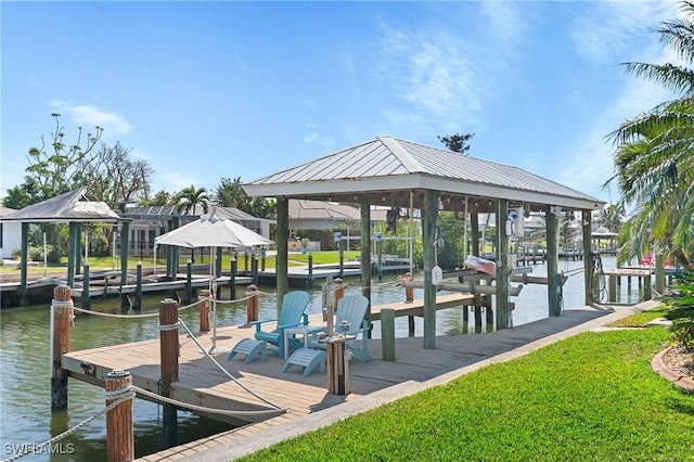 dock area with a gazebo, a water view, and boat lift