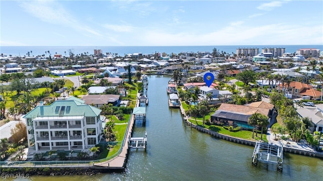 drone / aerial view featuring a residential view and a water view