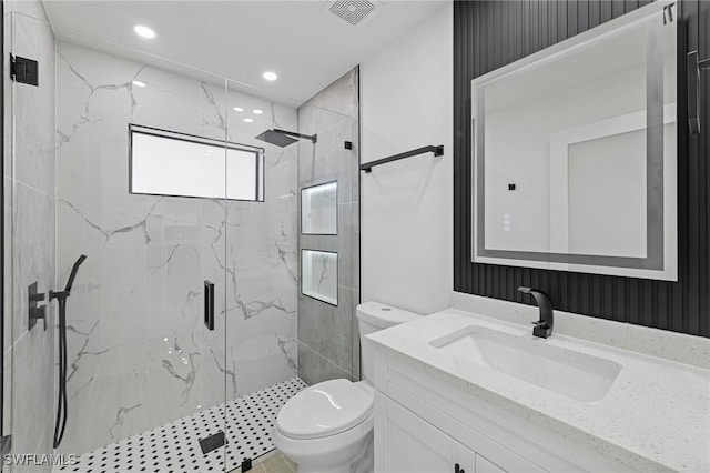 bathroom featuring vanity, toilet, and walk in shower