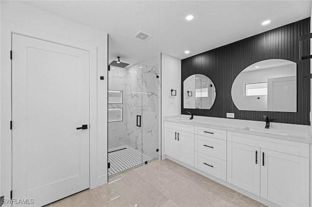 bathroom featuring vanity and a shower with door