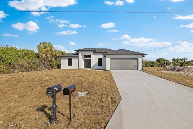 view of front facade featuring a garage and a front lawn