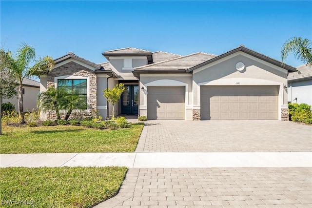 view of front of property with a garage and a front lawn