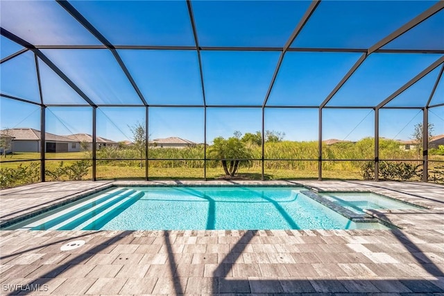 view of pool with an in ground hot tub, a lanai, and a patio