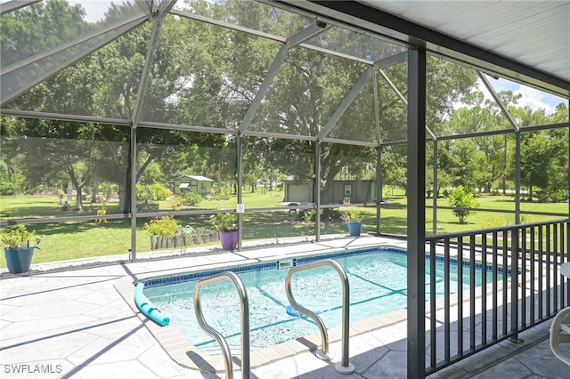 view of pool featuring a shed, a lanai, a lawn, and a patio