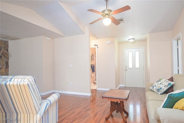 living room featuring hardwood / wood-style flooring, ceiling fan, and lofted ceiling