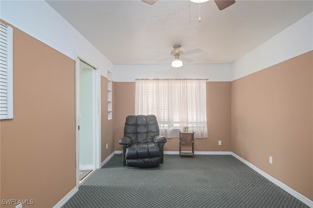 unfurnished room with ceiling fan, carpet floors, and a textured ceiling