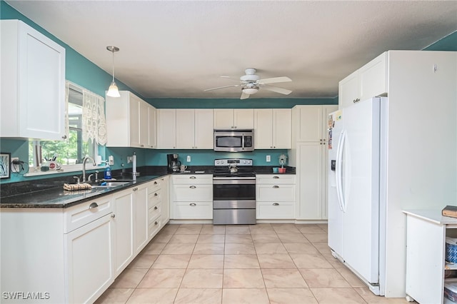 kitchen with stainless steel appliances, sink, hanging light fixtures, and white cabinets