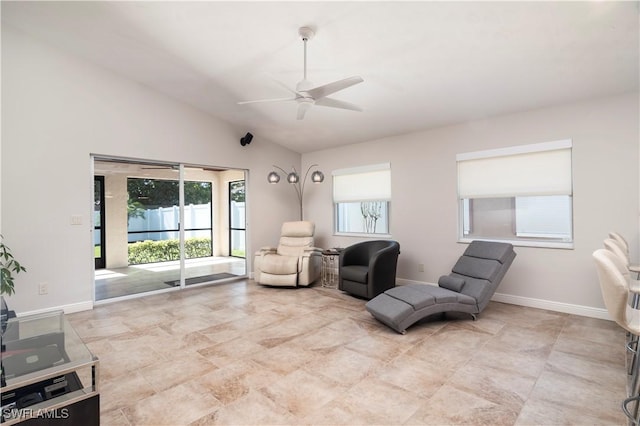 living area featuring ceiling fan, vaulted ceiling, and a wealth of natural light