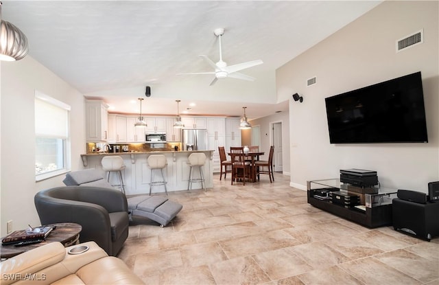 living room with high vaulted ceiling and ceiling fan