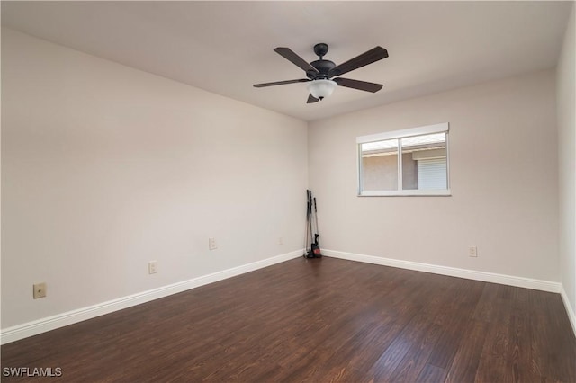 spare room featuring dark wood-type flooring and ceiling fan