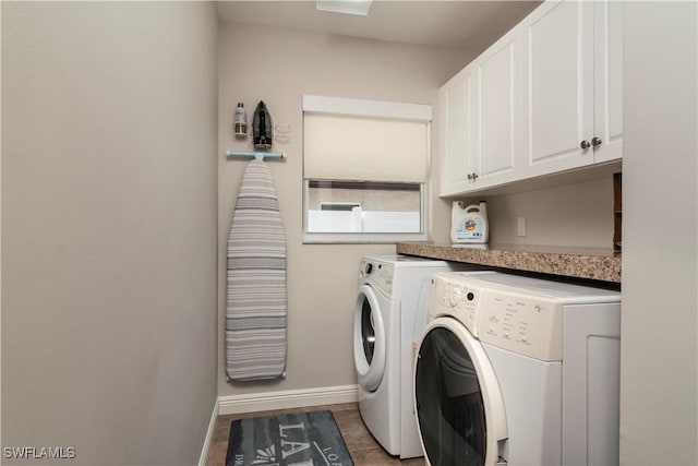 laundry room with washer and dryer and cabinets