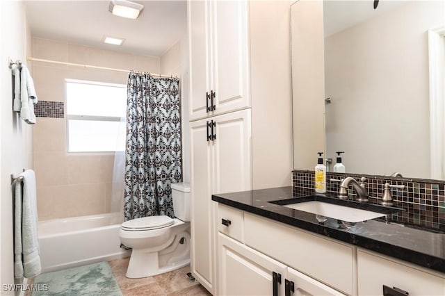 full bathroom featuring vanity, tile patterned flooring, toilet, and shower / bath combo with shower curtain