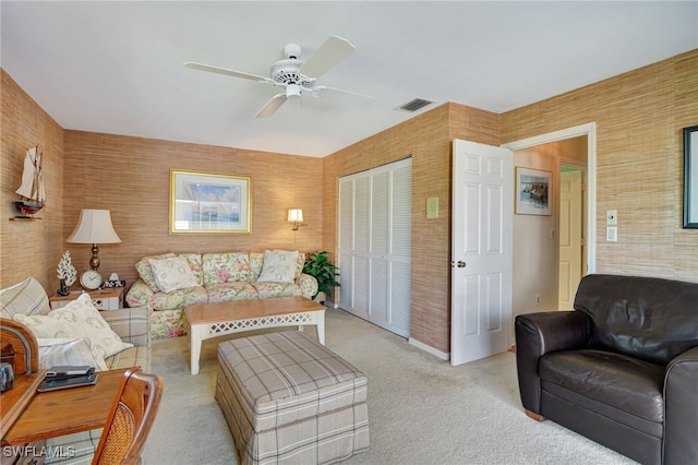 living room with light colored carpet and ceiling fan