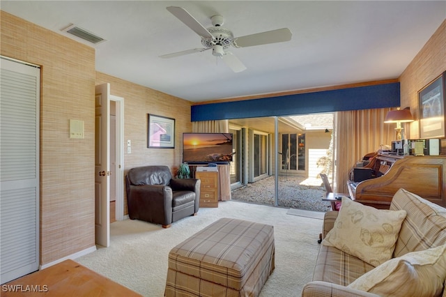 carpeted living room with ceiling fan