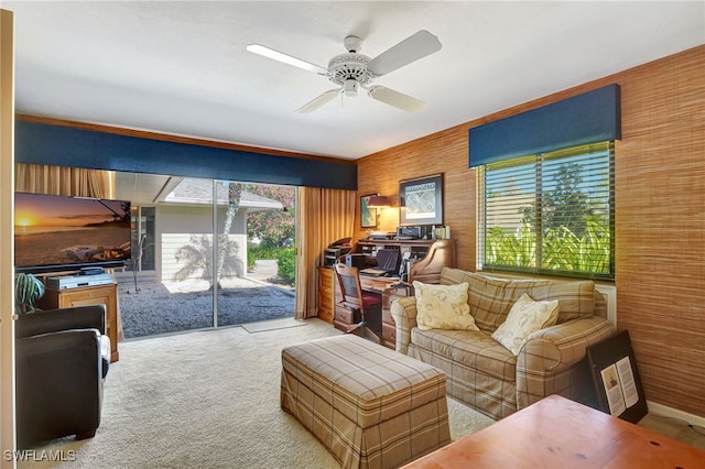 carpeted living room with ceiling fan and a healthy amount of sunlight