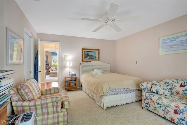 bedroom featuring ceiling fan and light carpet