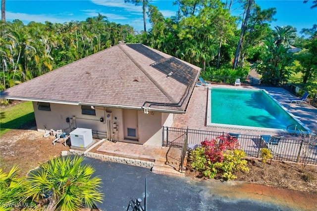 exterior space with a fenced in pool and a patio area