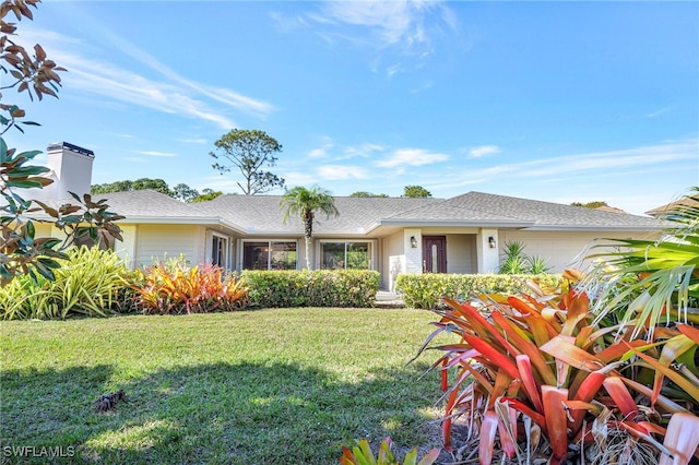 ranch-style home with a garage and a front yard