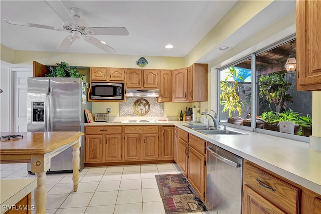 kitchen featuring light tile patterned flooring, sink, backsplash, ceiling fan, and stainless steel appliances