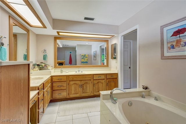 bathroom with vanity, a washtub, and tile patterned flooring