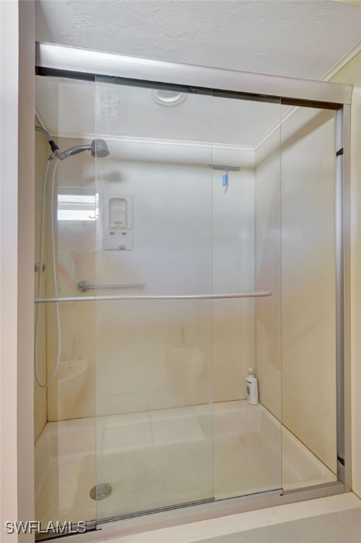 bathroom with a shower with shower door