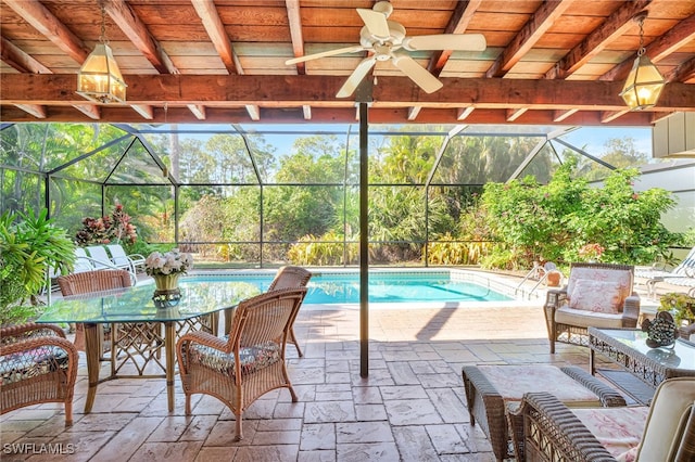 view of pool featuring a patio area, ceiling fan, and glass enclosure