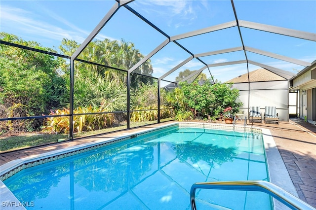 view of swimming pool with a lanai and a patio area