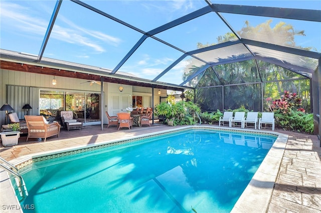 view of swimming pool with a lanai, ceiling fan, and a patio area