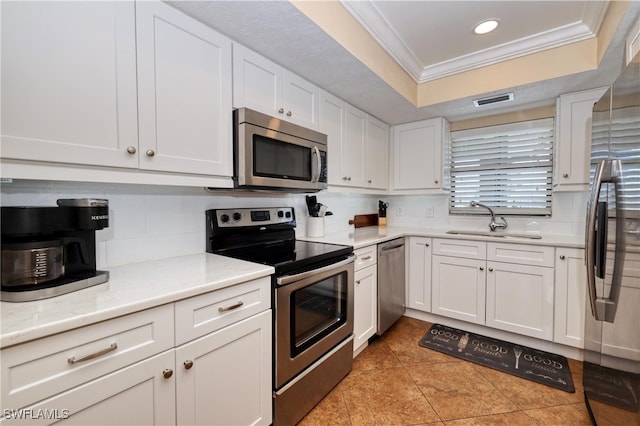 kitchen featuring white cabinetry, sink, ornamental molding, and stainless steel appliances