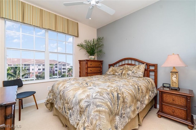 carpeted bedroom with vaulted ceiling and ceiling fan