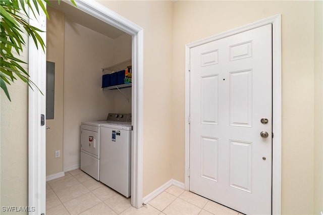 laundry room with light tile patterned floors, electric panel, and washer and clothes dryer