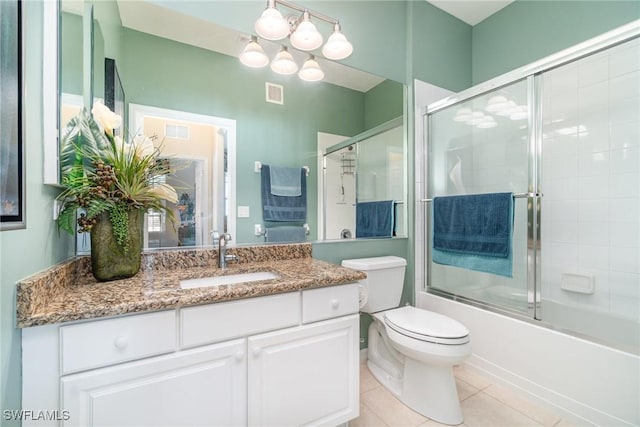 full bathroom with vanity, tile patterned floors, enclosed tub / shower combo, and toilet