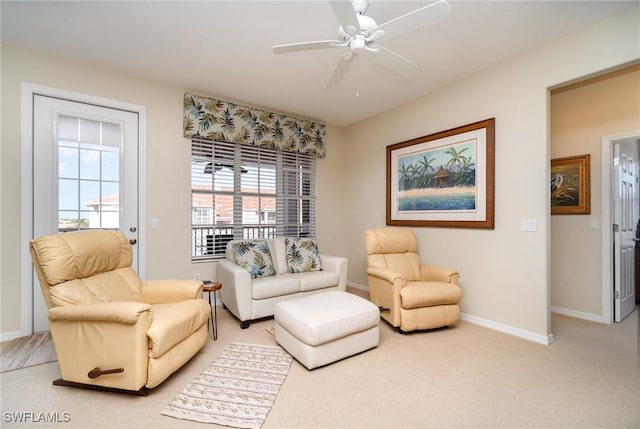 sitting room featuring light colored carpet and ceiling fan