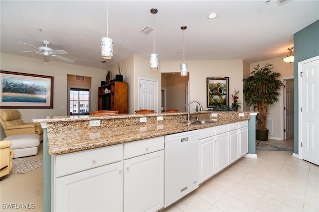 kitchen featuring white dishwasher, sink, decorative light fixtures, and white cabinets