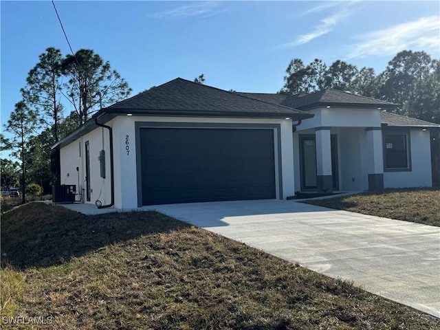 view of front of house featuring a garage and cooling unit