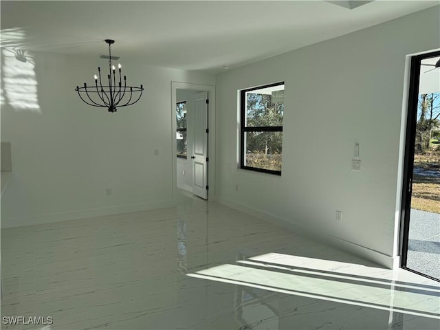 unfurnished room with an inviting chandelier