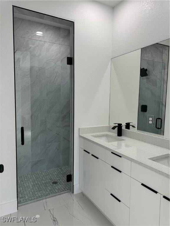 bathroom with vanity and a shower with door