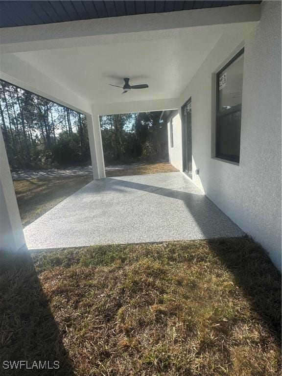 view of yard with a patio and ceiling fan