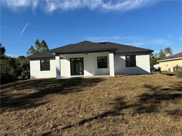 rear view of property with a patio area and a lawn